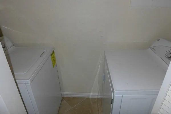 a bathroom with a granite countertop toilet and a sink