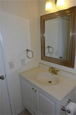 a bathroom with a sink a vanity and a mirror