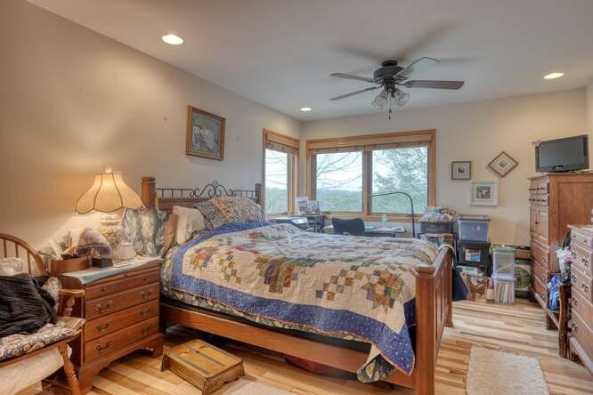 99 Old Possum Way Murphy, NC 28906 - Photo 16 of 54 a bedroom with a bed and large windows