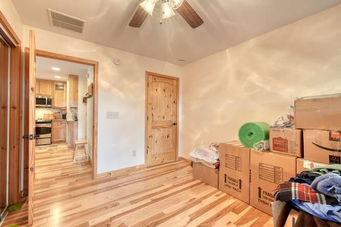 99 Old Possum Way Murphy, NC 28906 - Photo 19 of 54 a bedroom with a bed and wooden floor