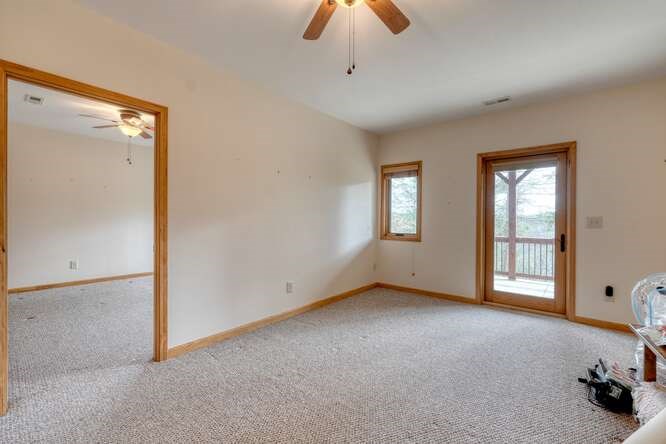 99 Old Possum Way Murphy, NC 28906 - Photo 26 of 54 an empty room with chandelier fan and windows