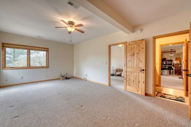 99 Old Possum Way Murphy, NC 28906 - Photo 28 of 54 an empty room with chandelier fan and windows