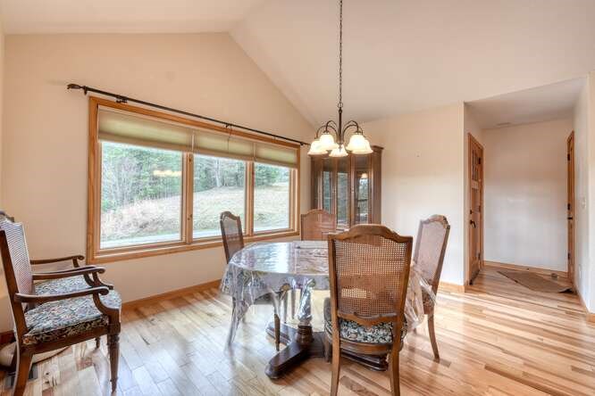 99 Old Possum Way Murphy, NC 28906 - Photo 9 of 54 a view of a dining room with furniture window and wooden floor