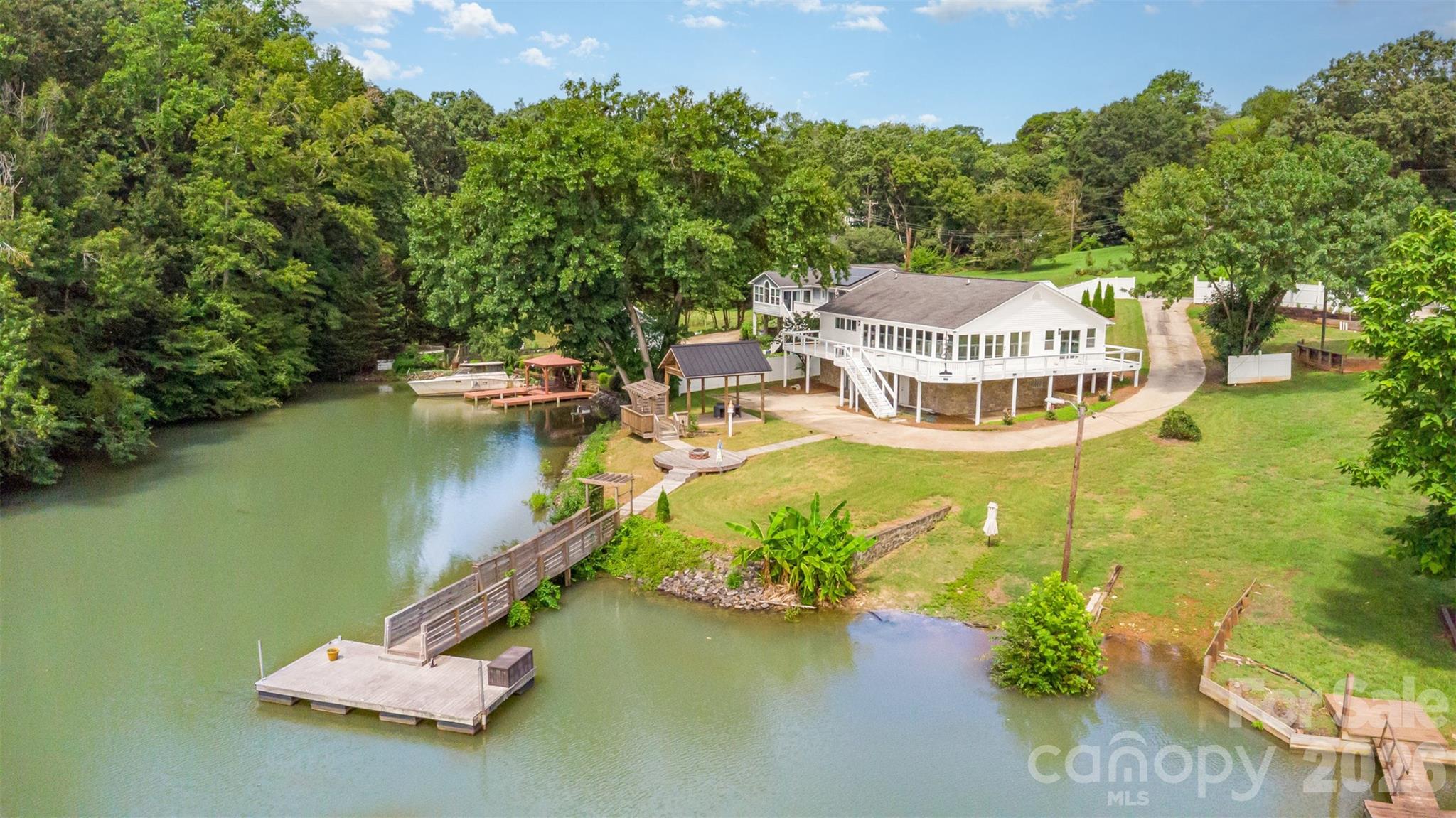 an aerial view of a house with a garden and lake view