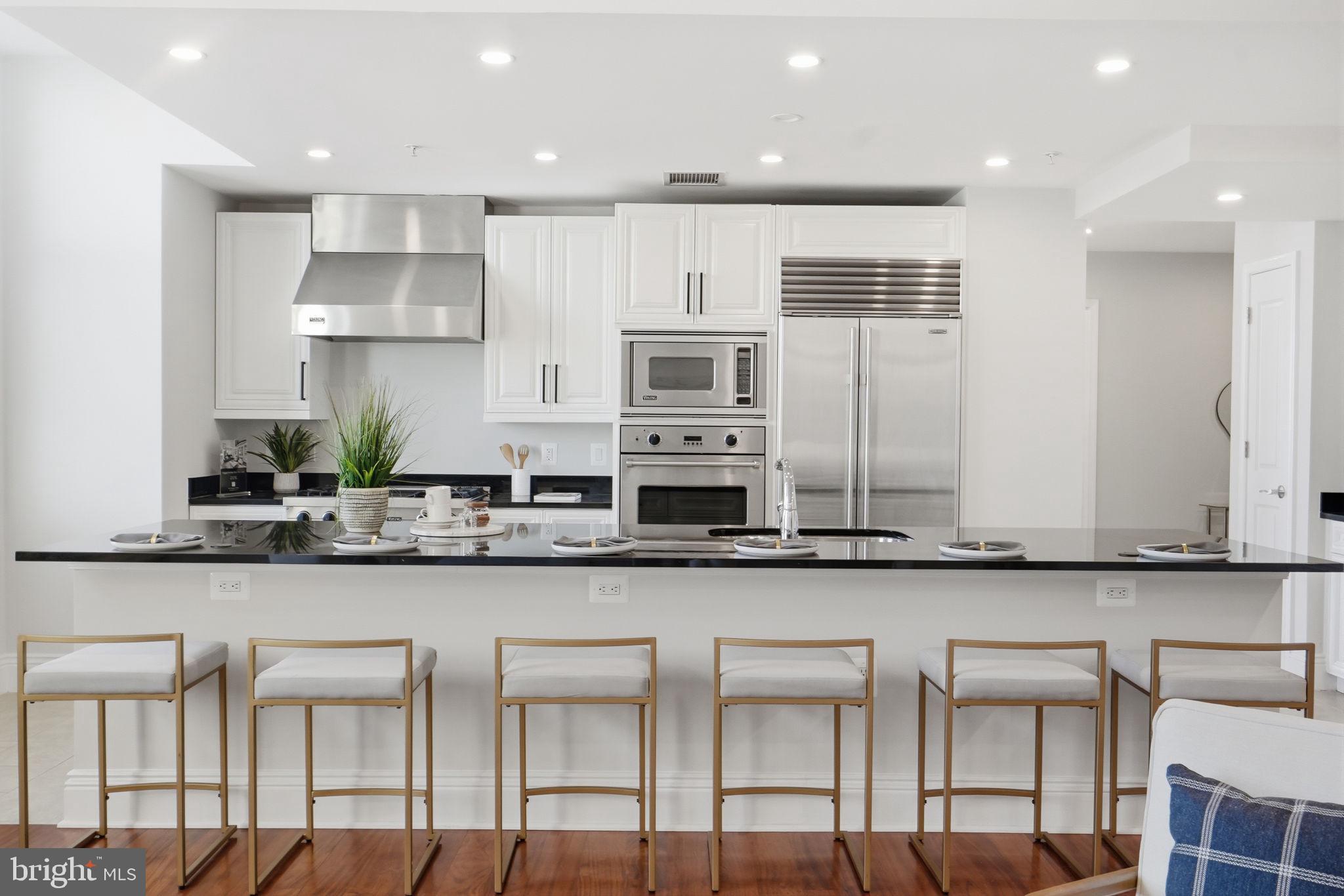 11990 Market Street, Unit 2103 Reston, VA 20190 - Photo 6 of 78 Sleek modern kitchen with elegant finishes.