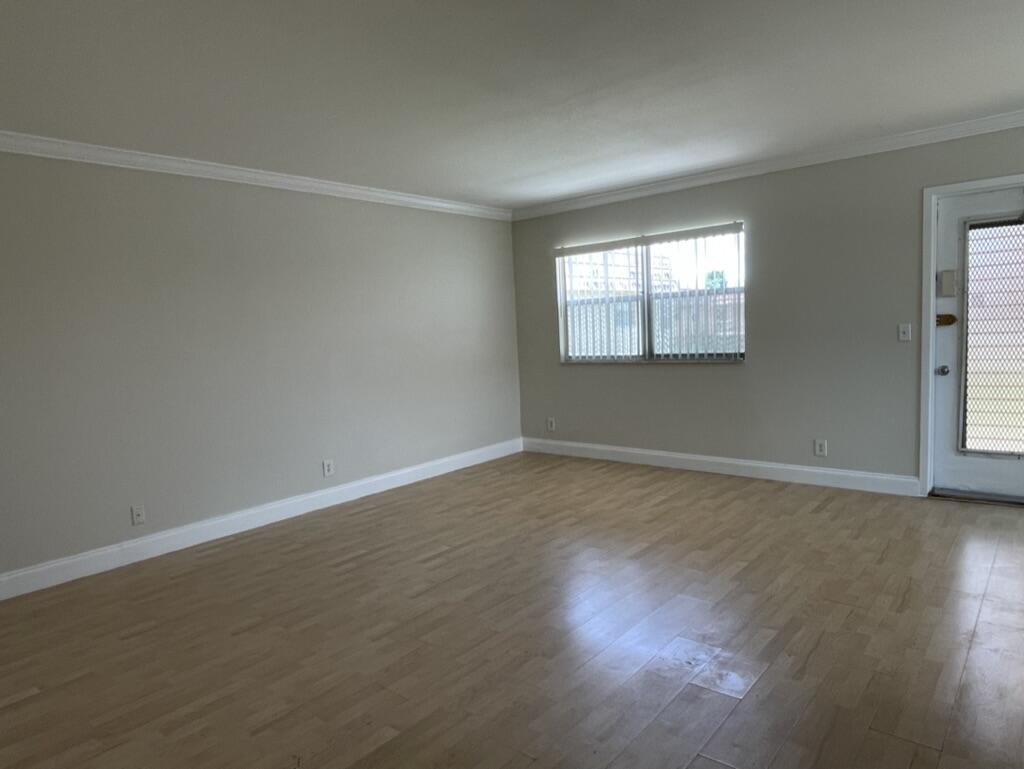 472 Saxony Way Delray Beach, FL 33446 - Photo 12 of 33 a view of an empty room with wooden floor and a window