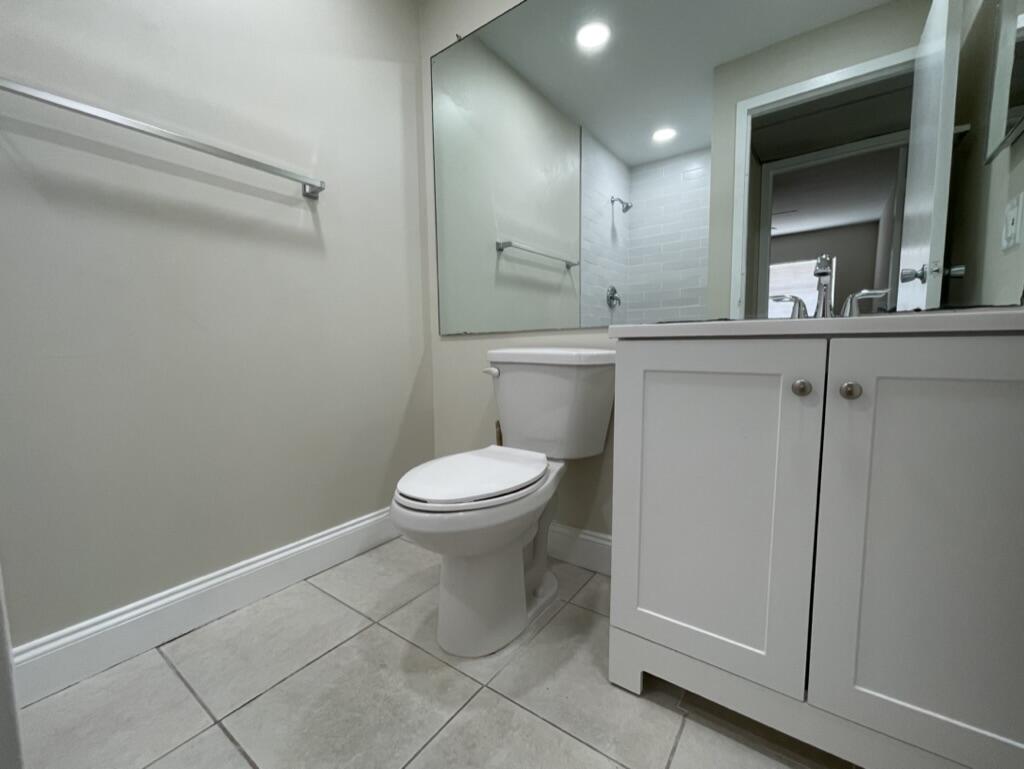 472 Saxony Way Delray Beach, FL 33446 - Photo 18 of 33 a bathroom with a toilet sink and mirror