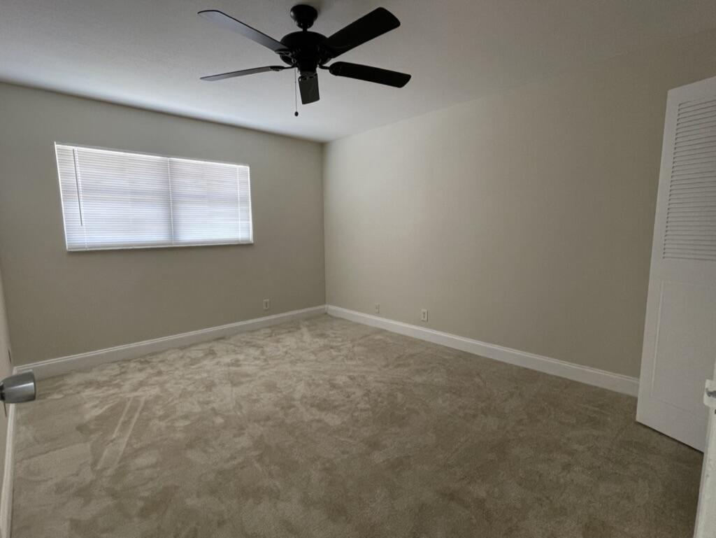 472 Saxony Way Delray Beach, FL 33446 - Photo 19 of 33 an empty room with a window and a fan