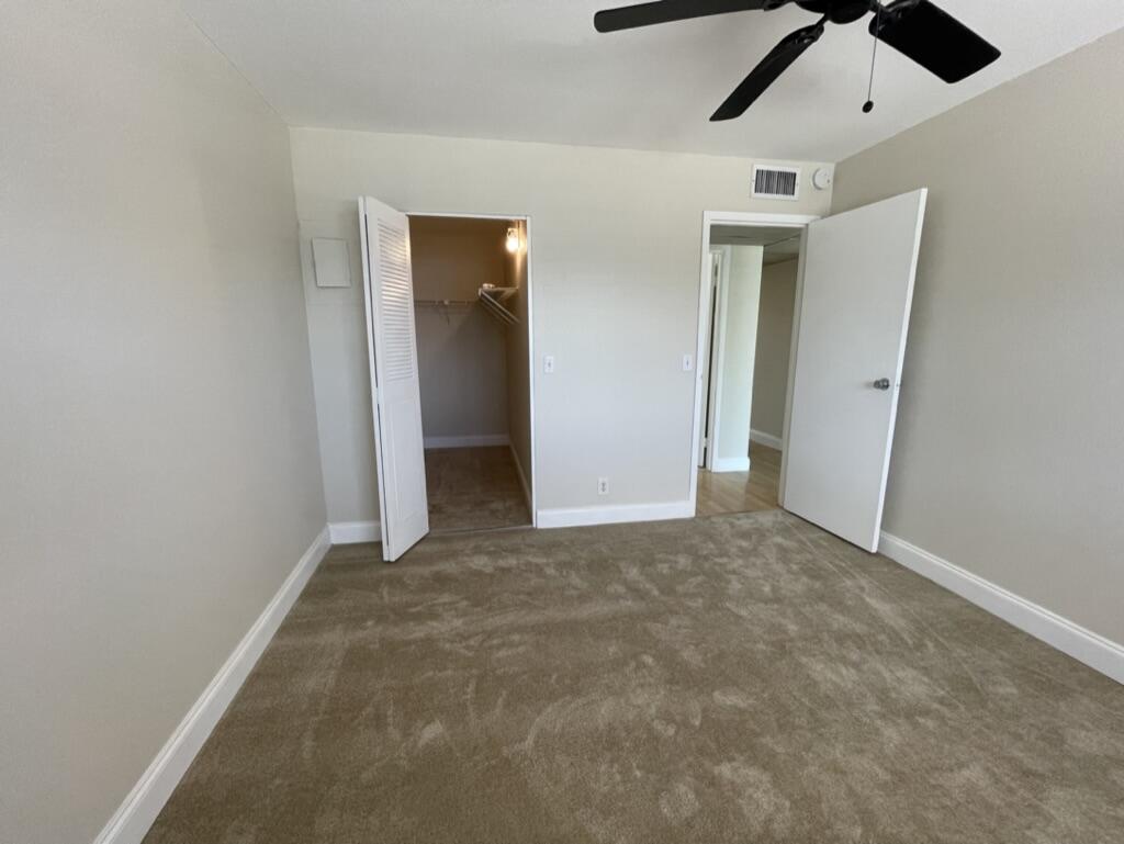 472 Saxony Way Delray Beach, FL 33446 - Photo 21 of 33 an empty room with ceiling fan and window