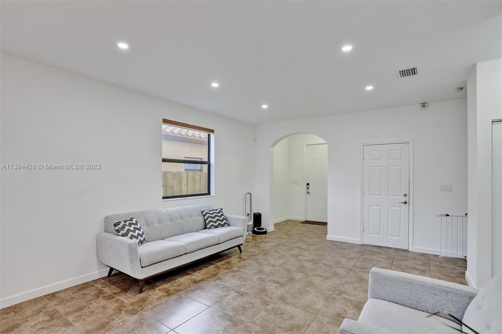 732 Southeast 33 Terrace Homestead, FL 33033 - Photo 11 of 65 a living room with furniture and a couch