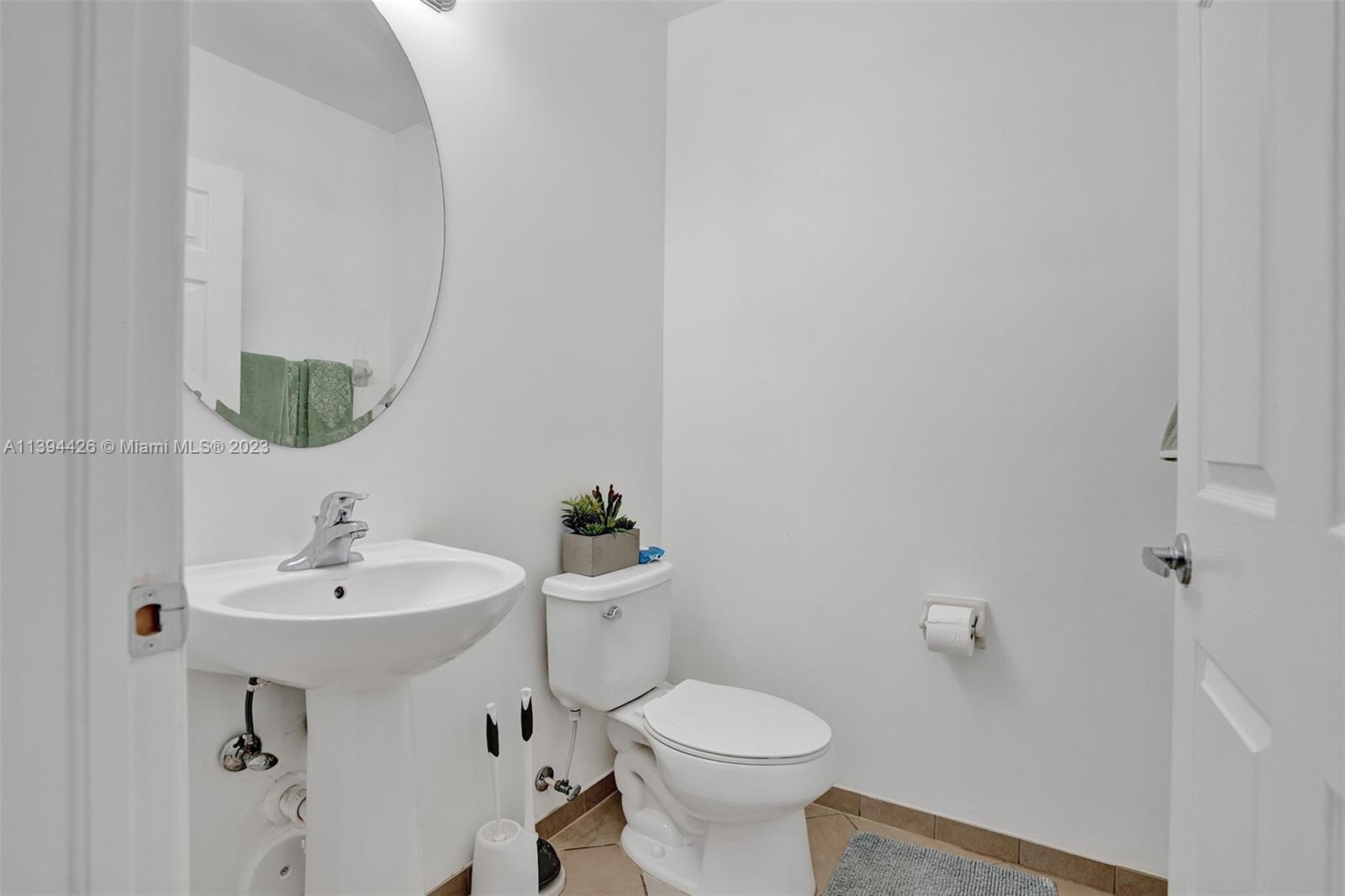 732 Southeast 33 Terrace Homestead, FL 33033 - Photo 13 of 65 a bathroom with a sink toilet and mirror