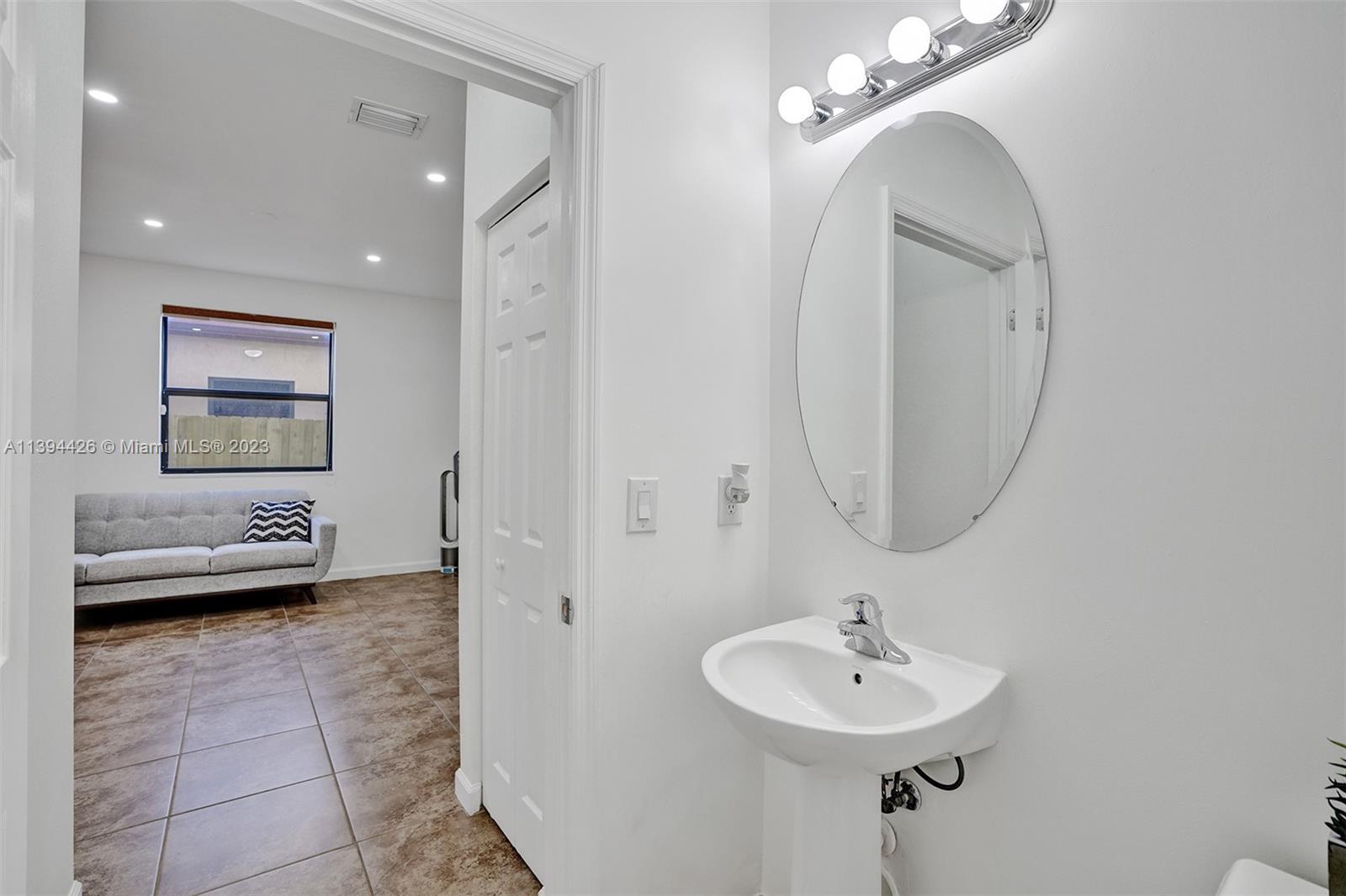 732 Southeast 33 Terrace Homestead, FL 33033 - Photo 14 of 65 a bathroom with a toilet a sink and mirror