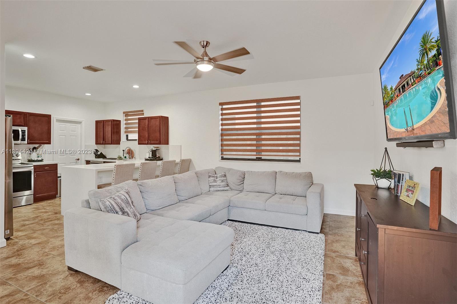 732 Southeast 33 Terrace Homestead, FL 33033 - Photo 16 of 65 a living room with furniture and a flat screen tv