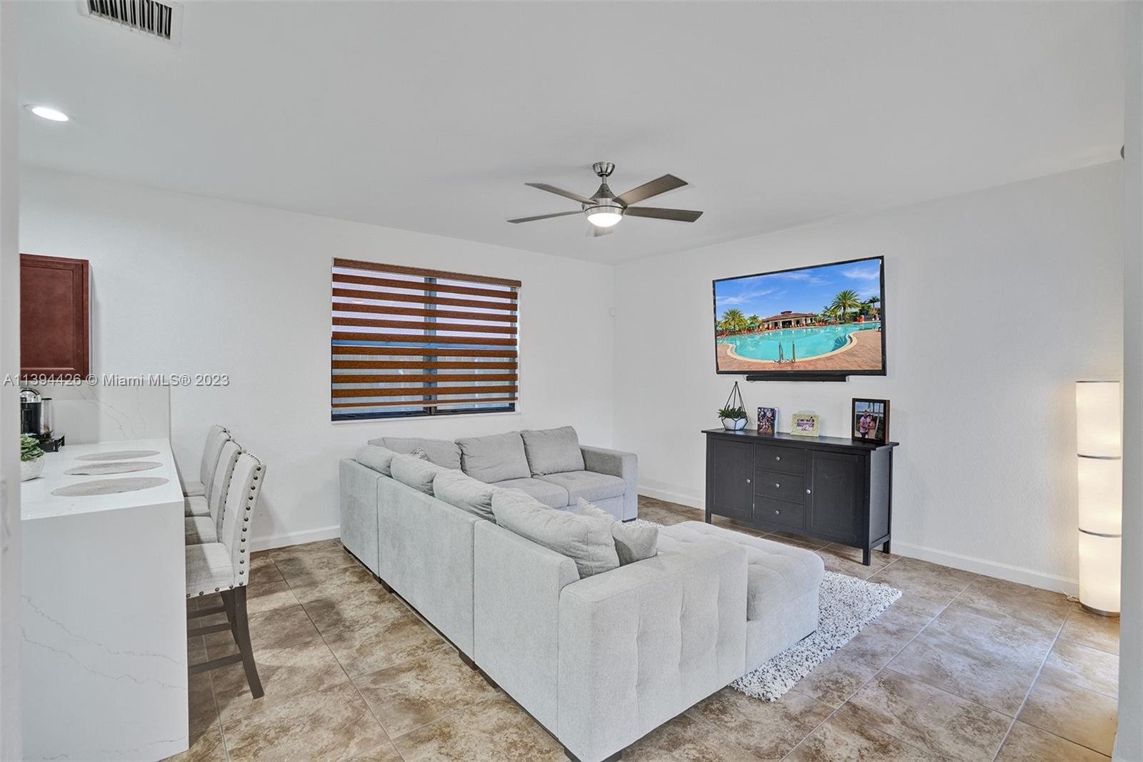 732 Southeast 33 Terrace Homestead, FL 33033 - Photo 18 of 65 a living room with furniture and a flat screen tv