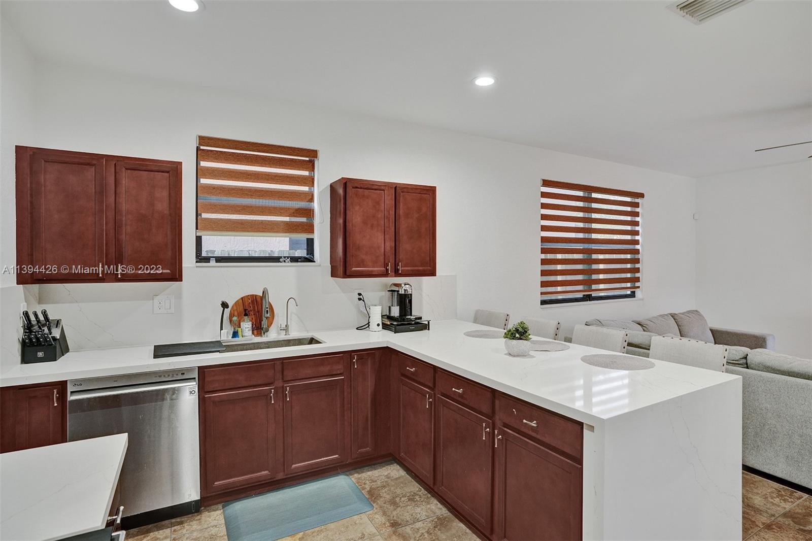 732 Southeast 33 Terrace Homestead, FL 33033 - Photo 23 of 65 a kitchen with a sink stove and cabinets
