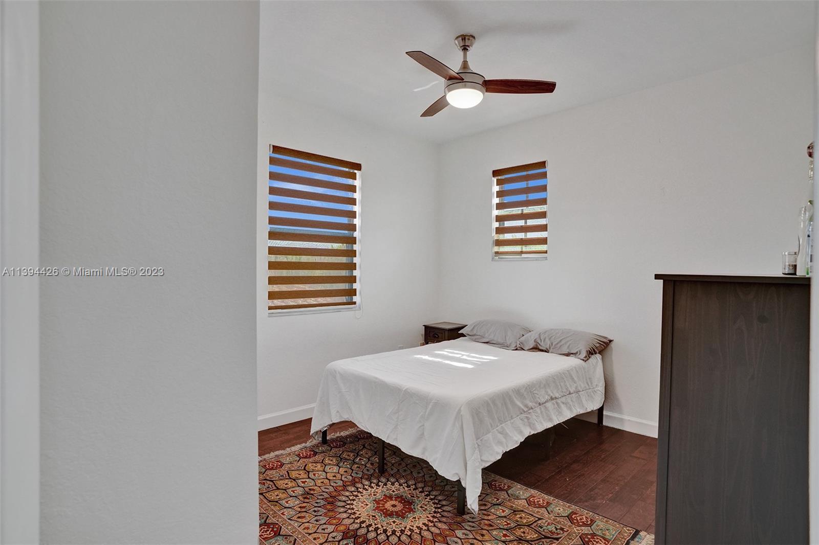 732 Southeast 33 Terrace Homestead, FL 33033 - Photo 29 of 65 a bed room with a bed and a chandelier