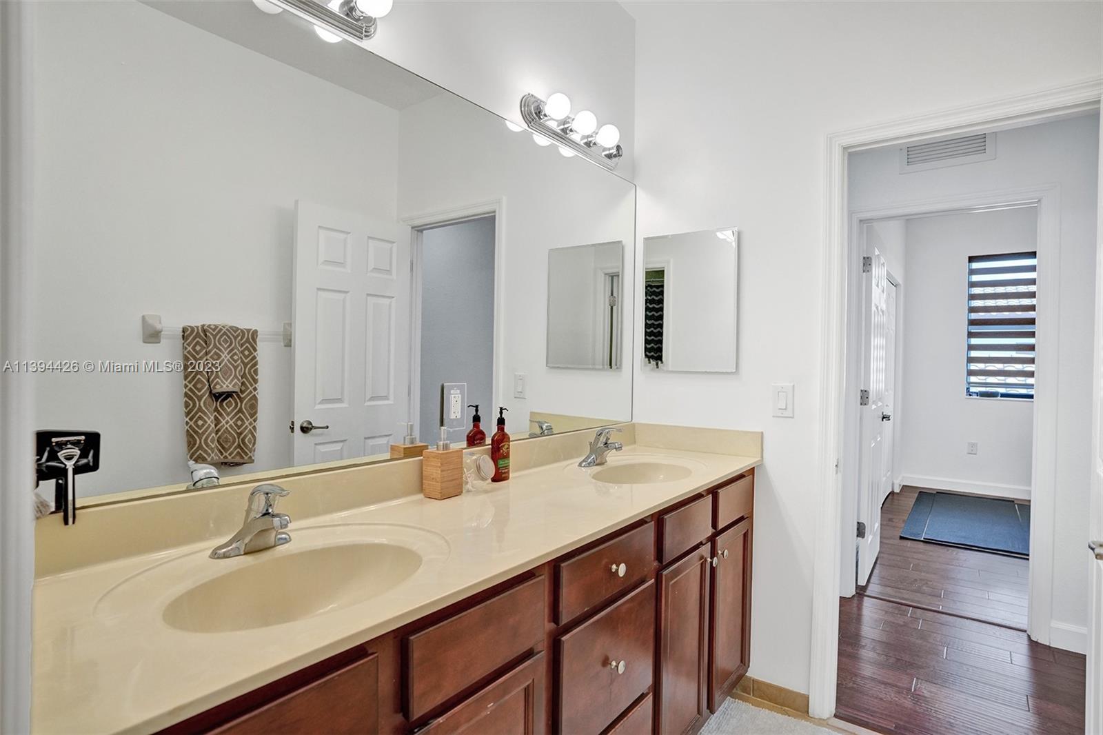 732 Southeast 33 Terrace Homestead, FL 33033 - Photo 38 of 65 a bathroom with a sink double vanity and a mirror