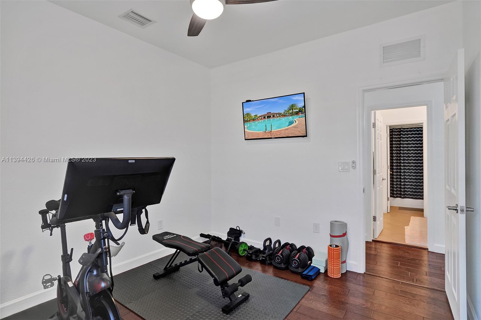 732 Southeast 33 Terrace Homestead, FL 33033 - Photo 39 of 65 a view of a workspace with furniture and wooden floor