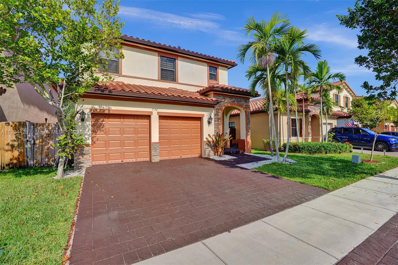 732 Southeast 33 Terrace Homestead, FL 33033 - Photo 4 of 65 a front view of a house with a yard and garage