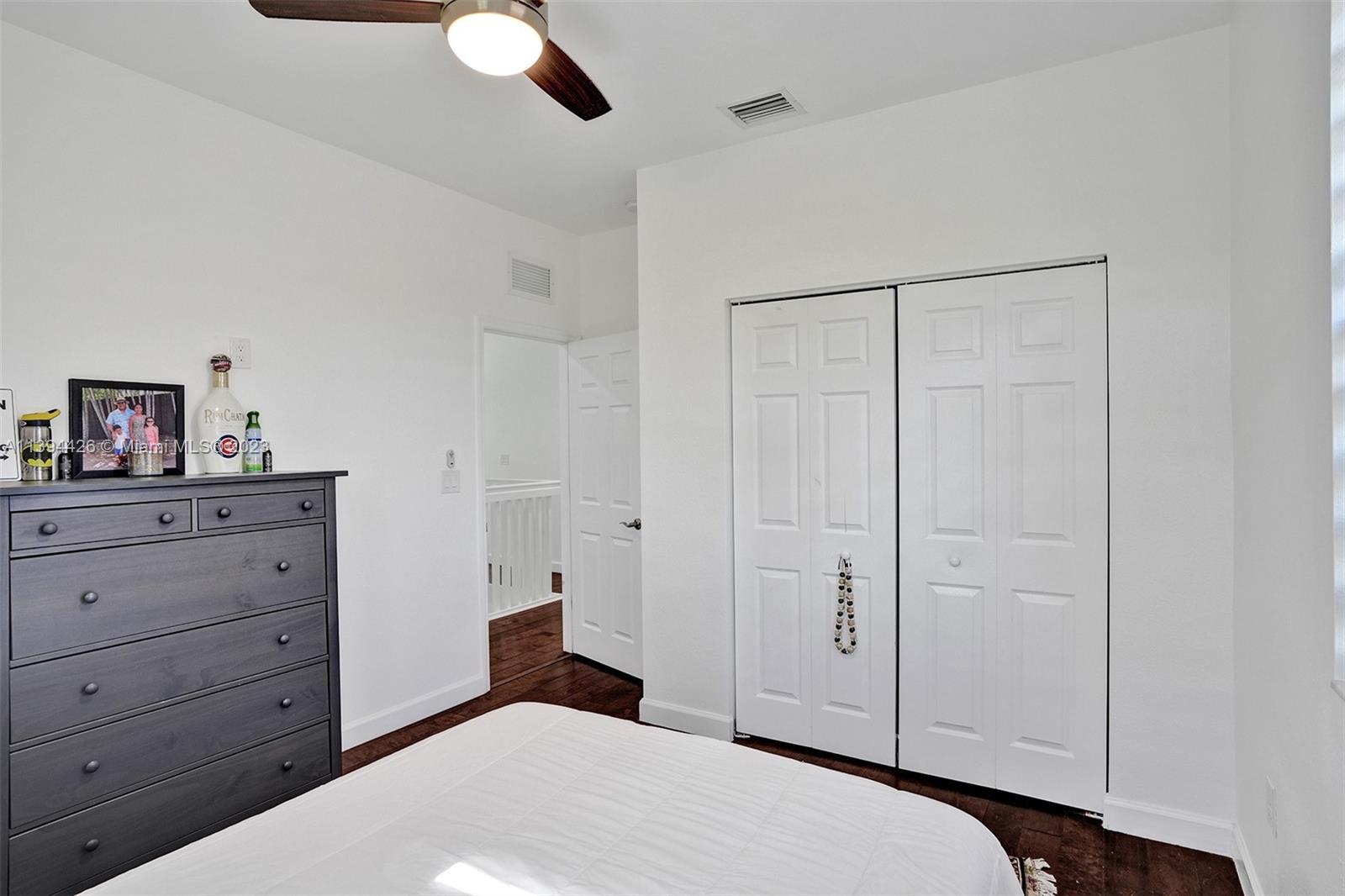 732 Southeast 33 Terrace Homestead, FL 33033 - Photo 43 of 65 a bedroom with a bed and a cabinet