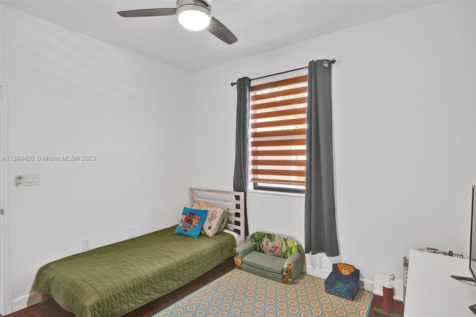 732 Southeast 33 Terrace Homestead, FL 33033 - Photo 44 of 65 a bedroom with a bed and a window