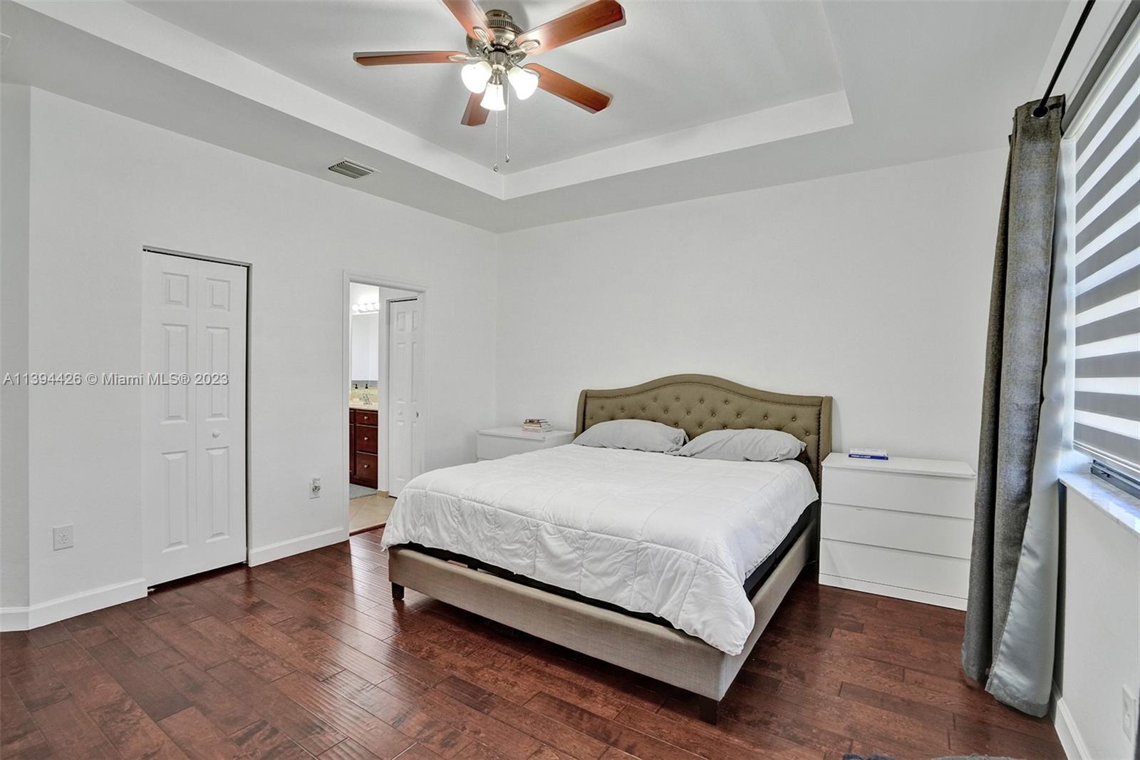 732 Southeast 33 Terrace Homestead, FL 33033 - Photo 47 of 65 a bedroom with a bed and a chandelier