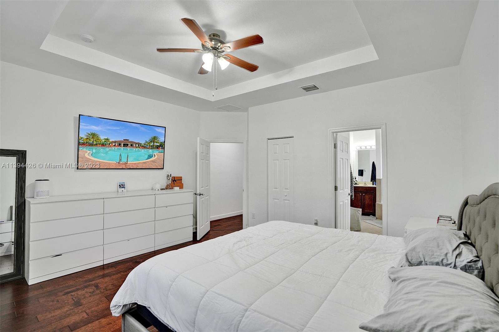 732 Southeast 33 Terrace Homestead, FL 33033 - Photo 48 of 65 a bedroom with a large bed and a chandelier