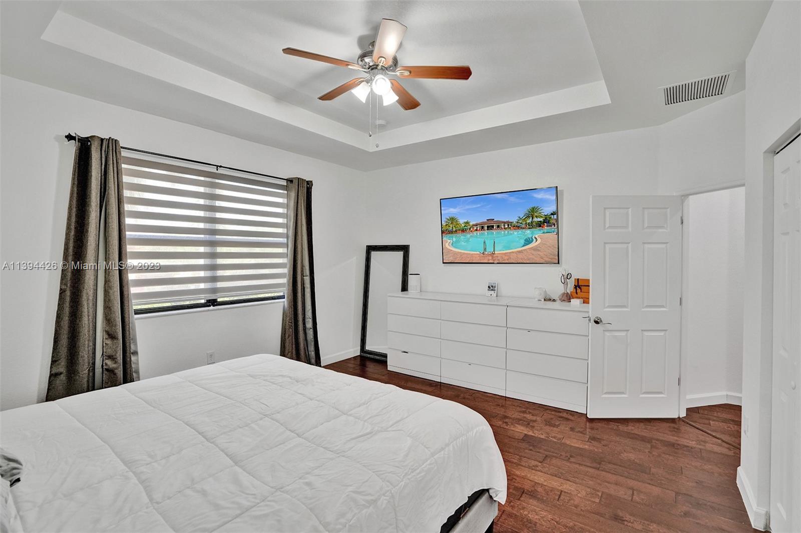 732 Southeast 33 Terrace Homestead, FL 33033 - Photo 49 of 65 a bedroom with a bed and a chandelier