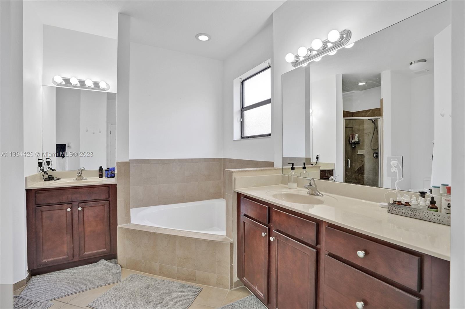 732 Southeast 33 Terrace Homestead, FL 33033 - Photo 51 of 65 a bathroom with a tub double sink and mirror