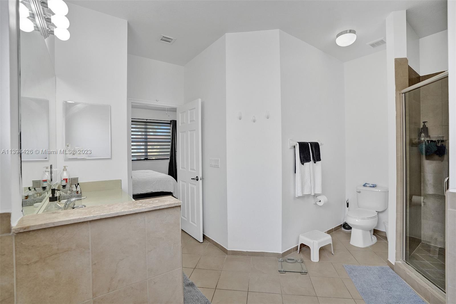 732 Southeast 33 Terrace Homestead, FL 33033 - Photo 53 of 65 a bathroom with a double vanity sink a toilet and a mirror