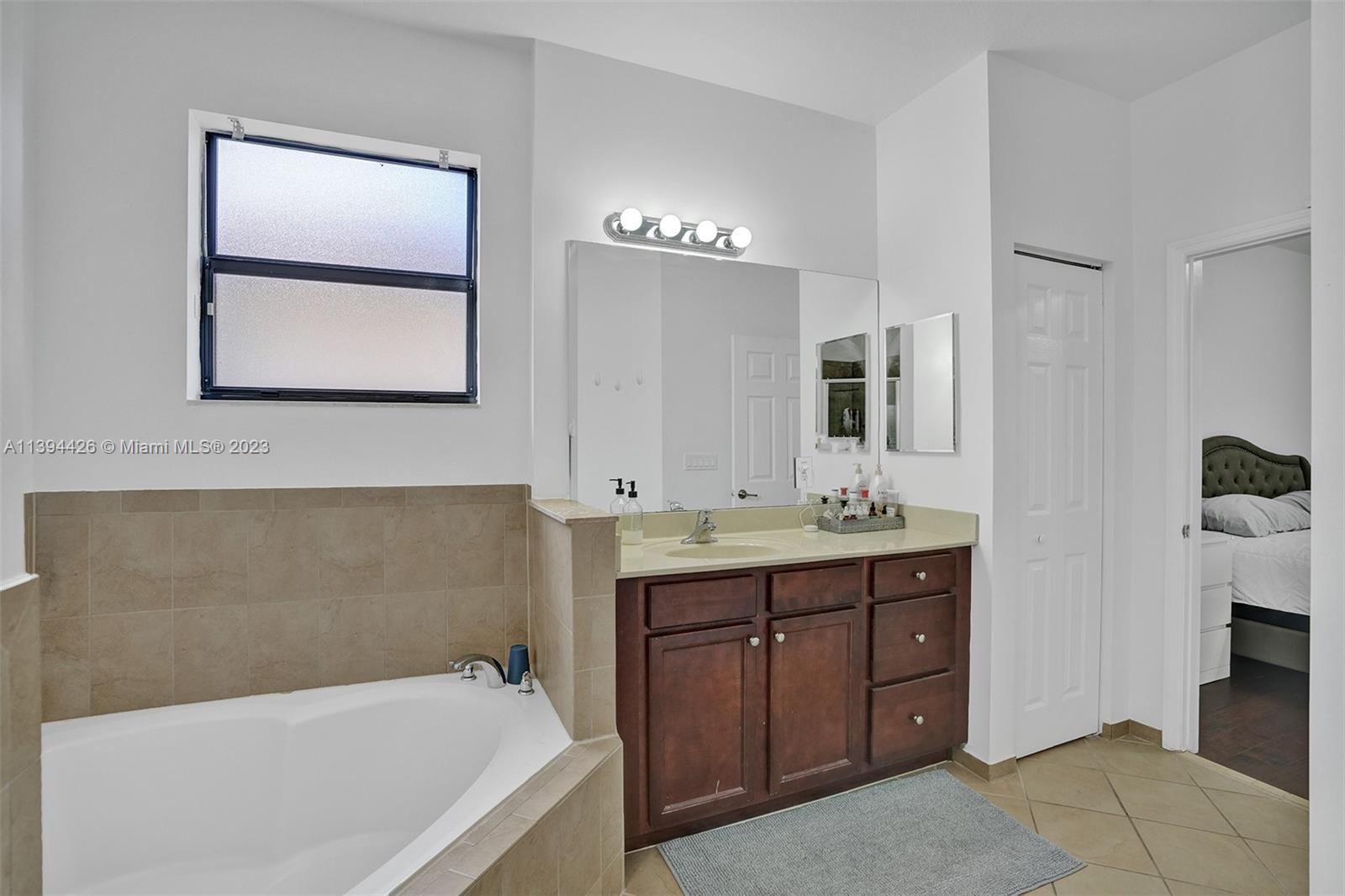 732 Southeast 33 Terrace Homestead, FL 33033 - Photo 54 of 65 a bathroom with a tub a sink and mirror