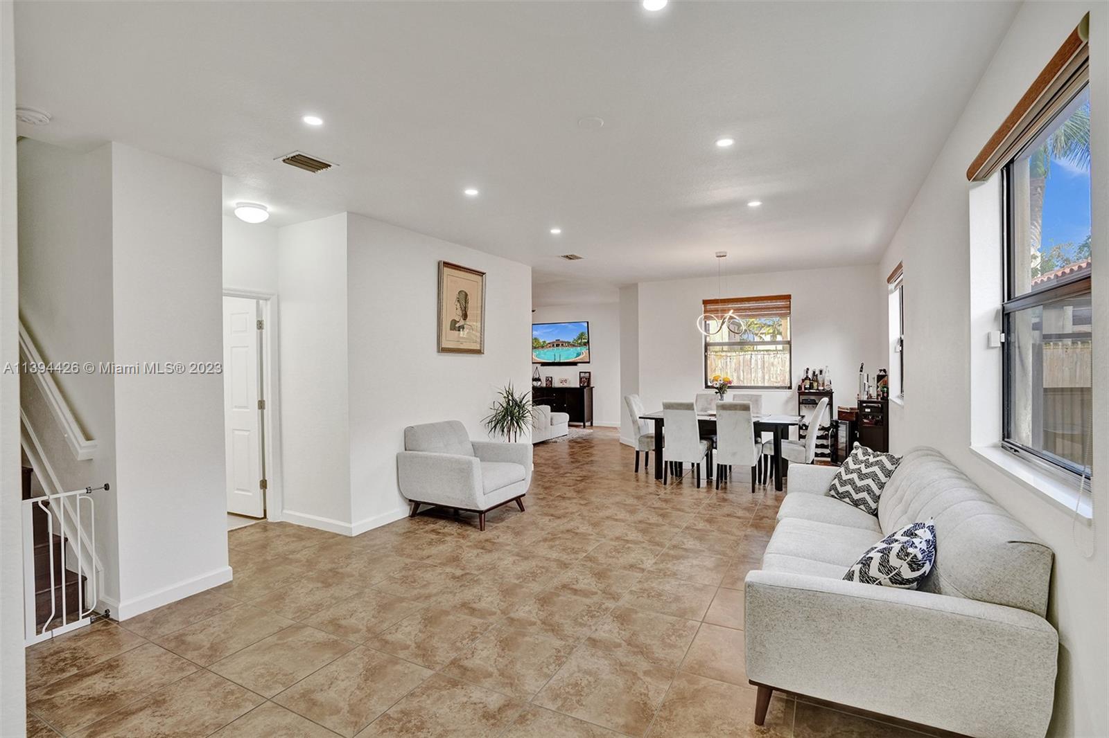 732 Southeast 33 Terrace Homestead, FL 33033 - Photo 6 of 65 a living room with furniture and a flat screen tv