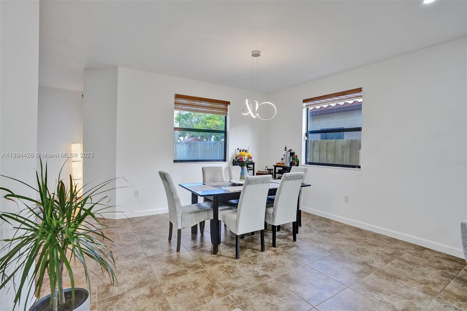 732 Southeast 33 Terrace Homestead, FL 33033 - Photo 8 of 65 a view of a dining room with furniture and a potted plant