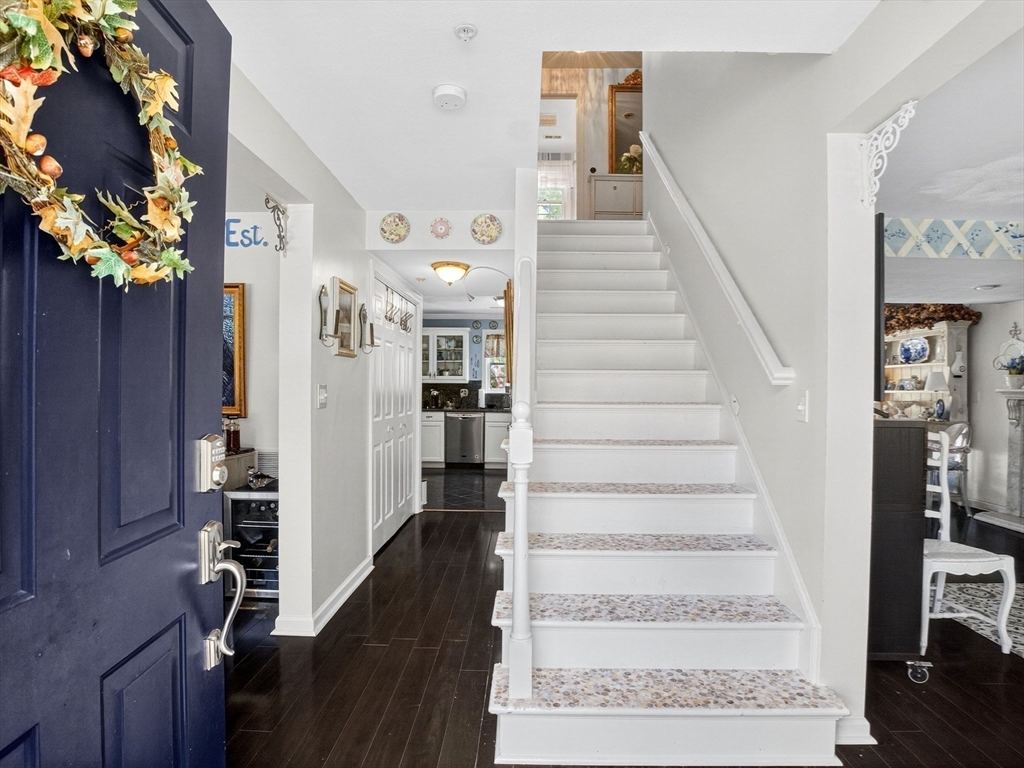 127 Clear Pond Drive, Unit 127 Walpole, MA 02081 - Photo 13 of 38 a view of a hallway with wooden floor and stairs