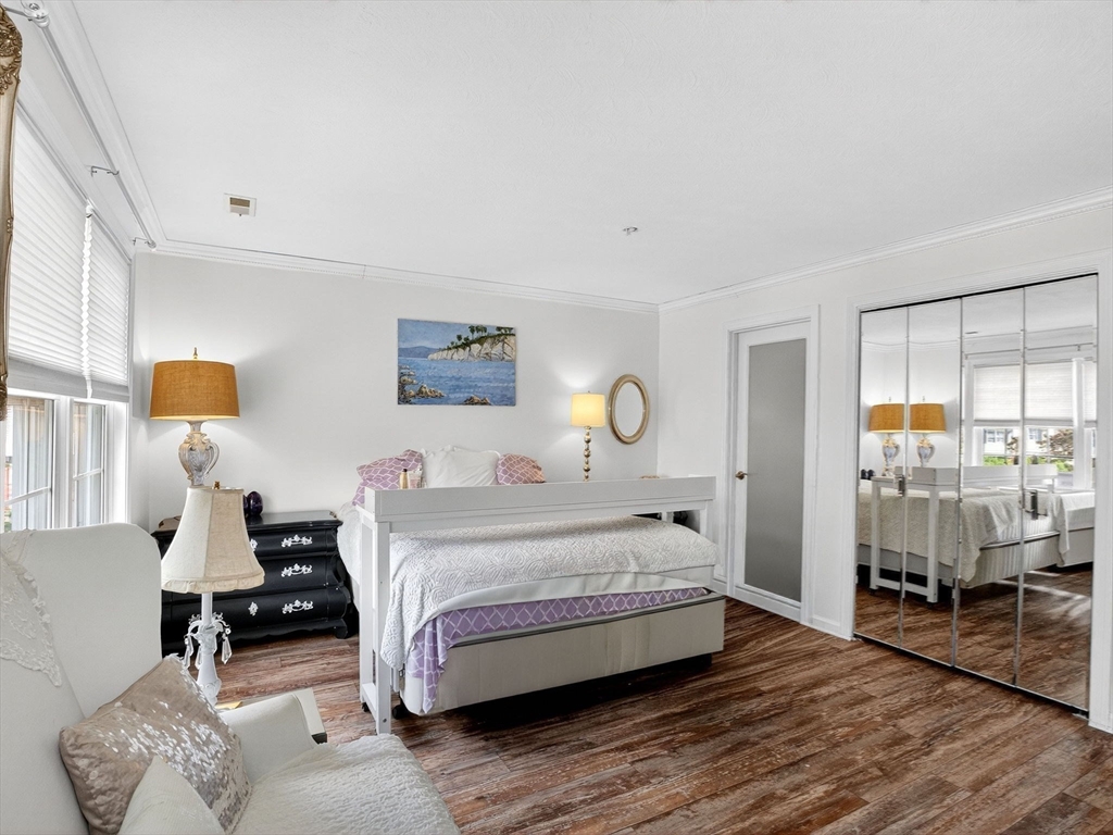 127 Clear Pond Drive, Unit 127 Walpole, MA 02081 - Photo 18 of 38 a bedroom with a bed and wooden floor