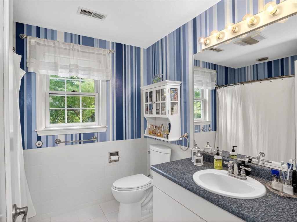 127 Clear Pond Drive, Unit 127 Walpole, MA 02081 - Photo 19 of 38 a bathroom with a granite countertop sink and a large mirror