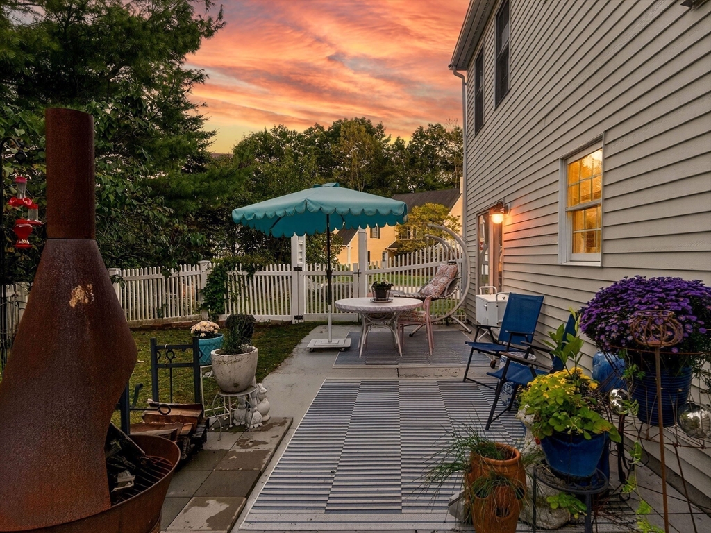127 Clear Pond Drive, Unit 127 Walpole, MA 02081 - Photo 30 of 38 a view of a chairs and table in the patio
