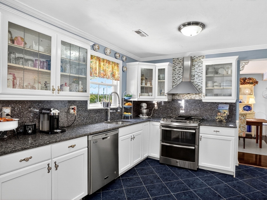 127 Clear Pond Drive, Unit 127 Walpole, MA 02081 - Photo 7 of 38 a kitchen with stainless steel appliances a stove sink and cabinets