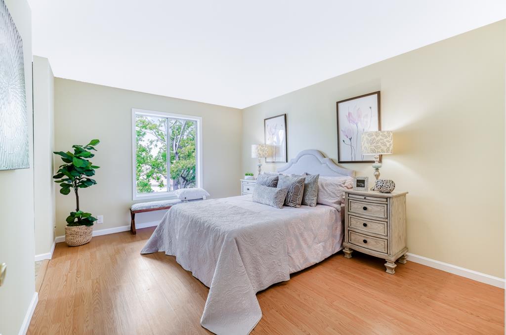 38455 Bronson Street, Unit 322 Fremont, CA 94536 - Photo 14 of 35 a bedroom with a bed and a potted plant