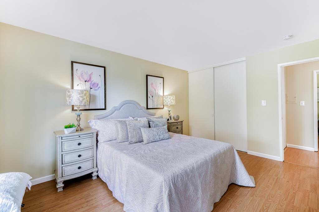38455 Bronson Street, Unit 322 Fremont, CA 94536 - Photo 17 of 35 a bedroom with a bed and a wooden floor