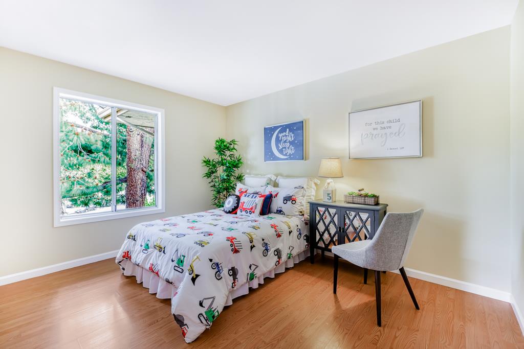38455 Bronson Street, Unit 322 Fremont, CA 94536 - Photo 23 of 35 a bedroom with a bed and a table