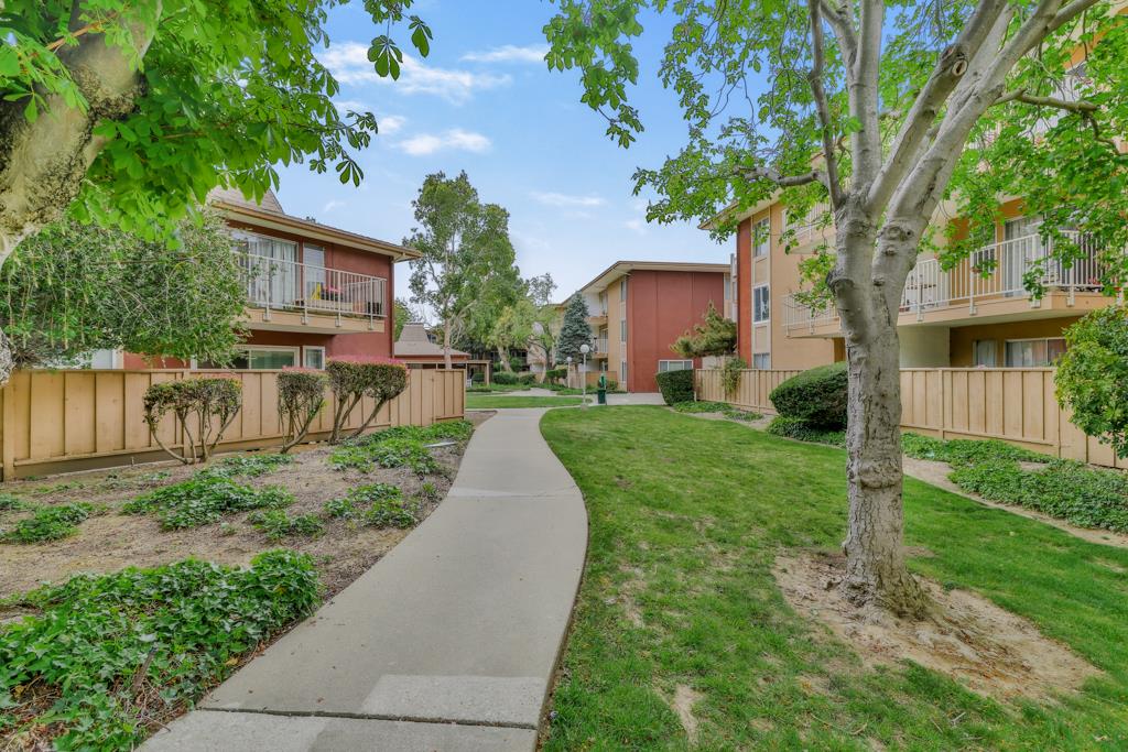 38455 Bronson Street, Unit 322 Fremont, CA 94536 - Photo 31 of 35 a front view of a house with a yard and green space