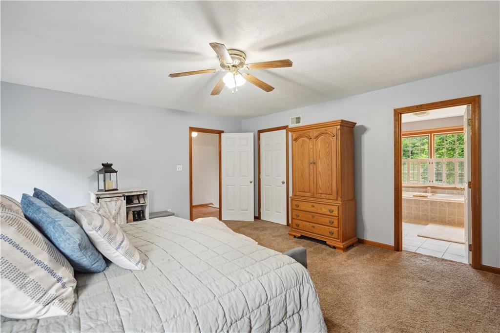 565 Leeper Road Georgetown, PA 15043 - Photo 20 of 46 a bedroom with a large bed and a chandelier