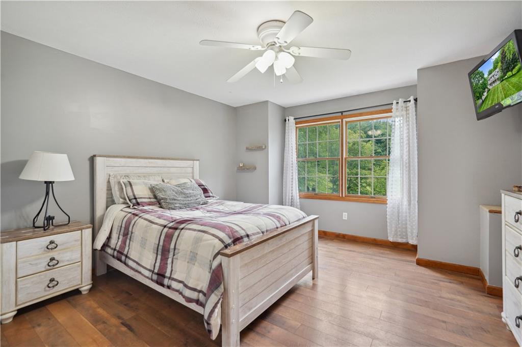 565 Leeper Road Georgetown, PA 15043 - Photo 23 of 46 a bedroom with a large bed and a chandelier