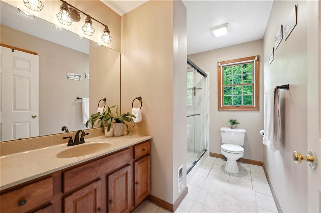 565 Leeper Road Georgetown, PA 15043 - Photo 24 of 46 a bathroom with a sink double vanity and a toilet