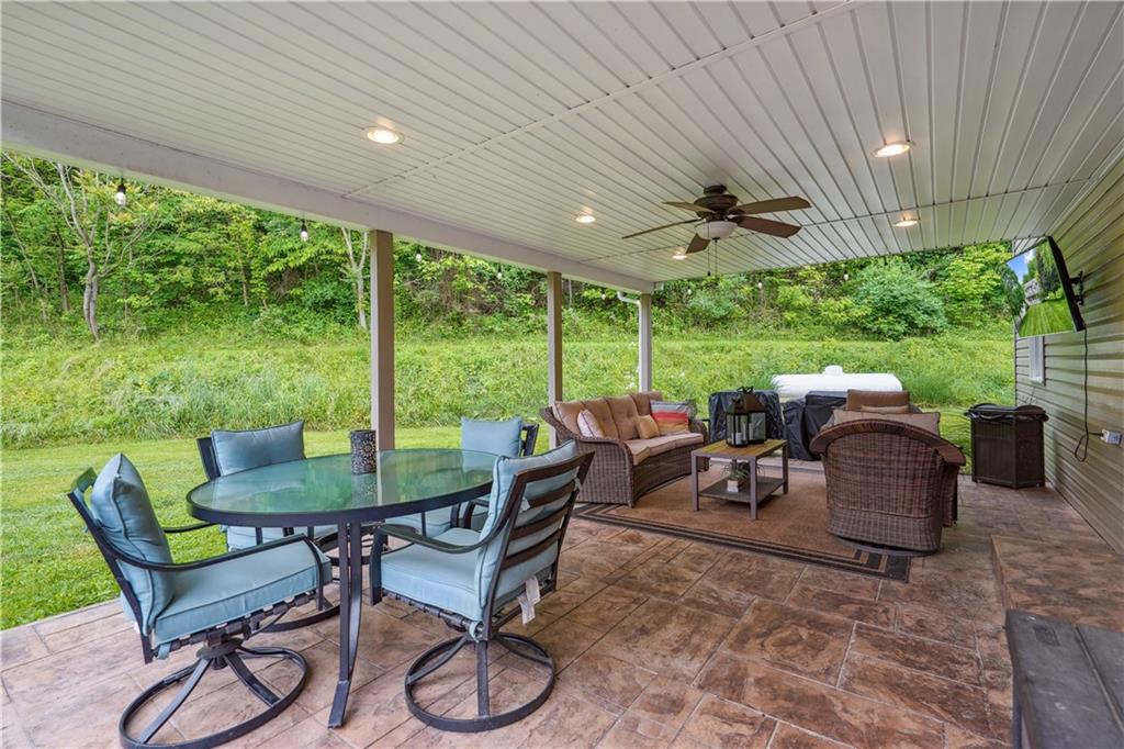 565 Leeper Road Georgetown, PA 15043 - Photo 34 of 46 a view of a patio with a table chairs and a backyard