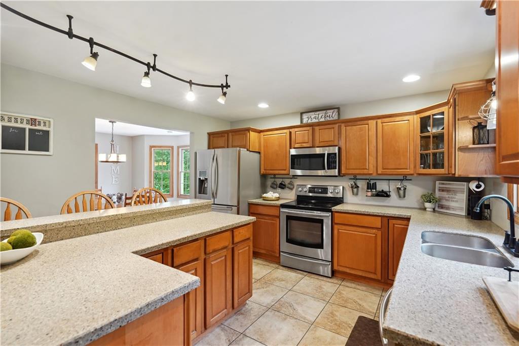 565 Leeper Road Georgetown, PA 15043 - Photo 6 of 46 a kitchen with stainless steel appliances granite countertop a sink stove and refrigerator