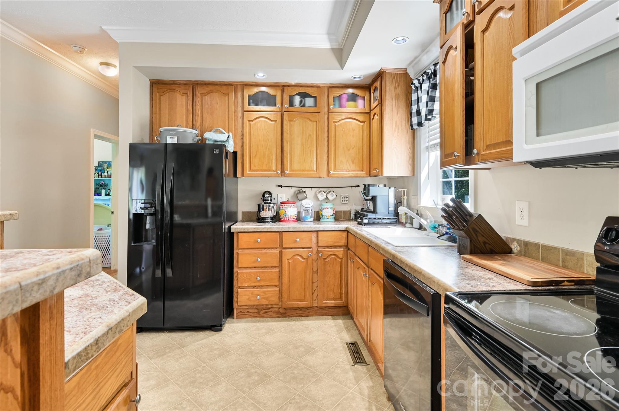 371 Starnes Cove Road Candler, NC 28715 - Photo 8 of 21 a kitchen with a refrigerator and a stove top oven