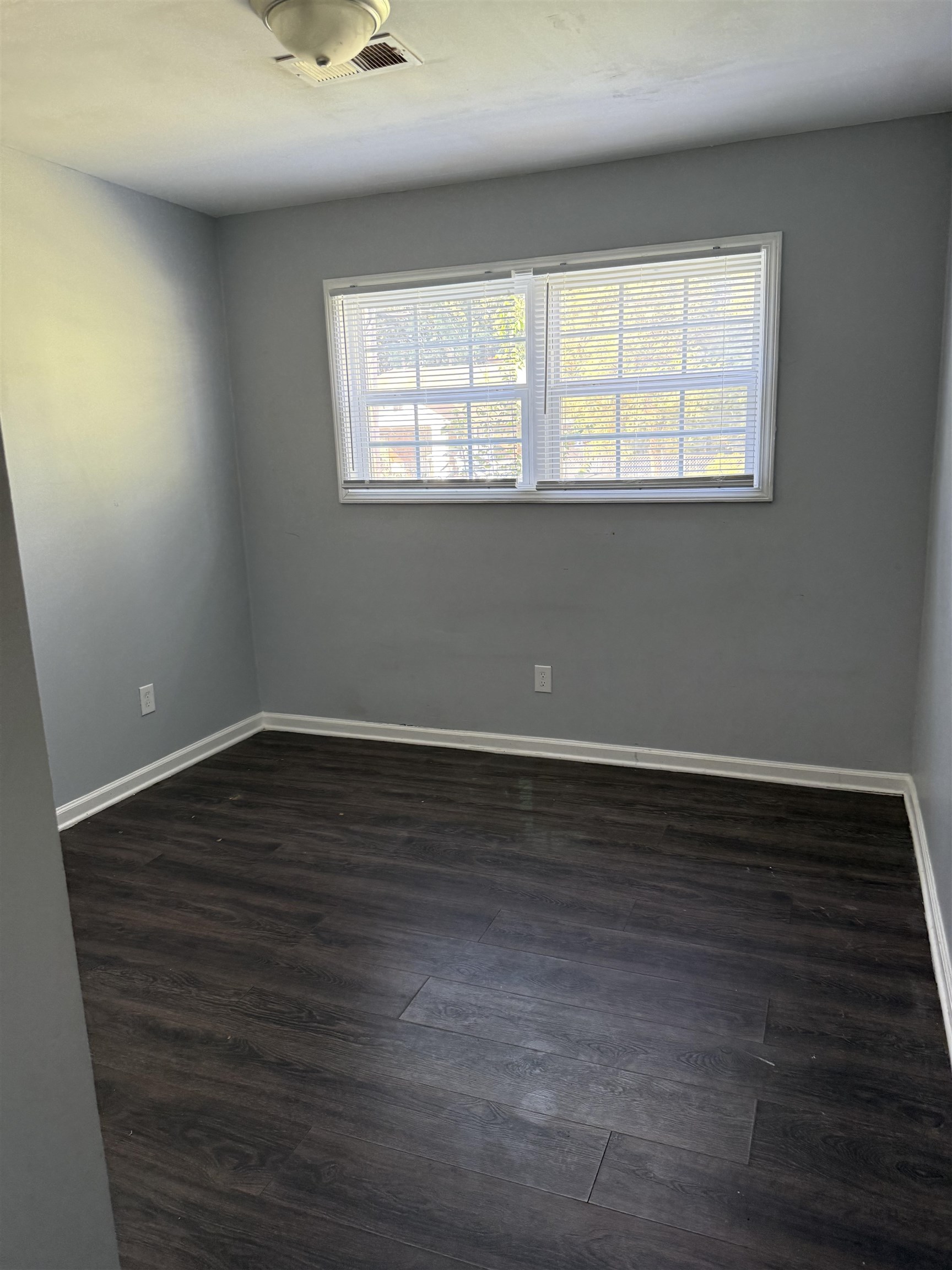 710 Hudson Street Memphis, TN 38112 - Photo 11 of 11 a view of an empty room with wooden floor and a window