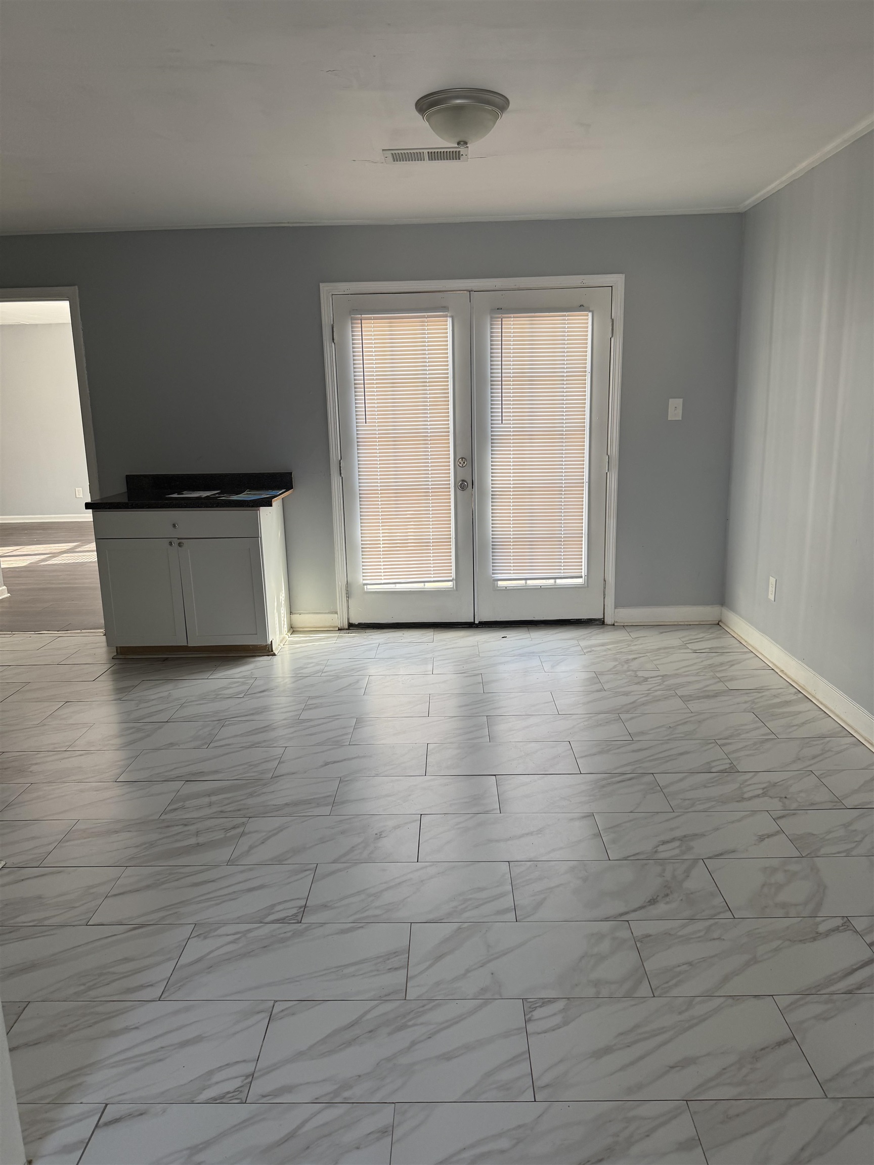 710 Hudson Street Memphis, TN 38112 - Photo 9 of 11 wooden floor in an empty room with a window